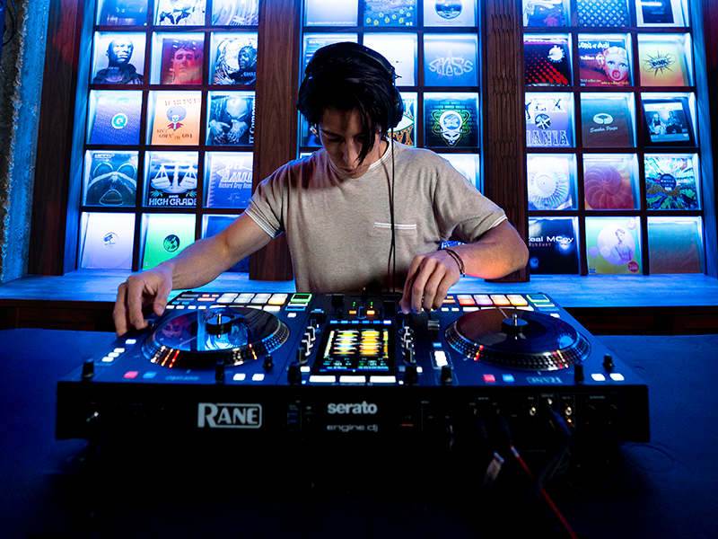 Sequence showing DJ equipment setup with blue backlit panels. Professional mixing console and equipment visible across multiple connected panels showing different angles.