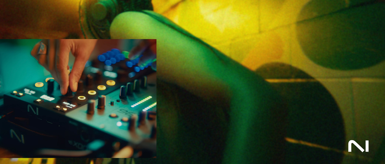 Close-up abstract photograph showing colorful macro detail of electronic circuit board or hardware components with cyan, green, and yellow lighting effects creating technological texture and depth.