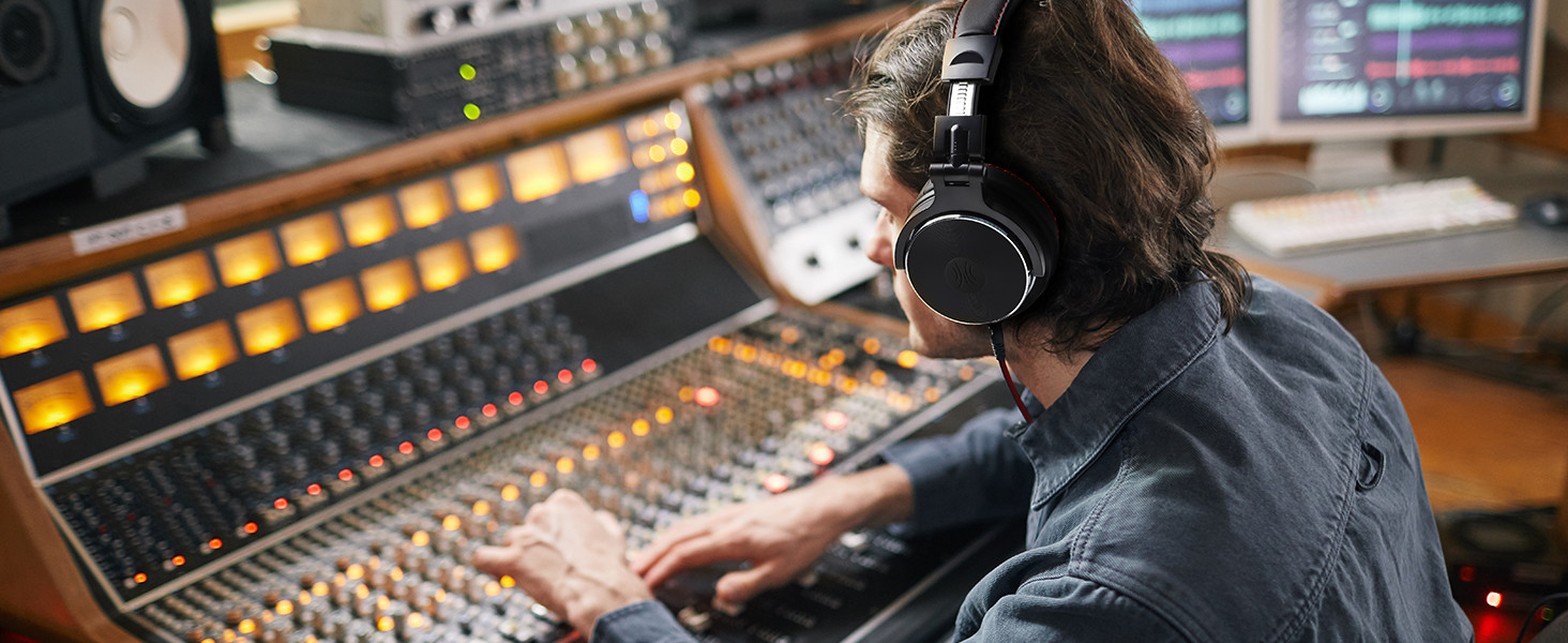 a man wearing headphones and a mixing board