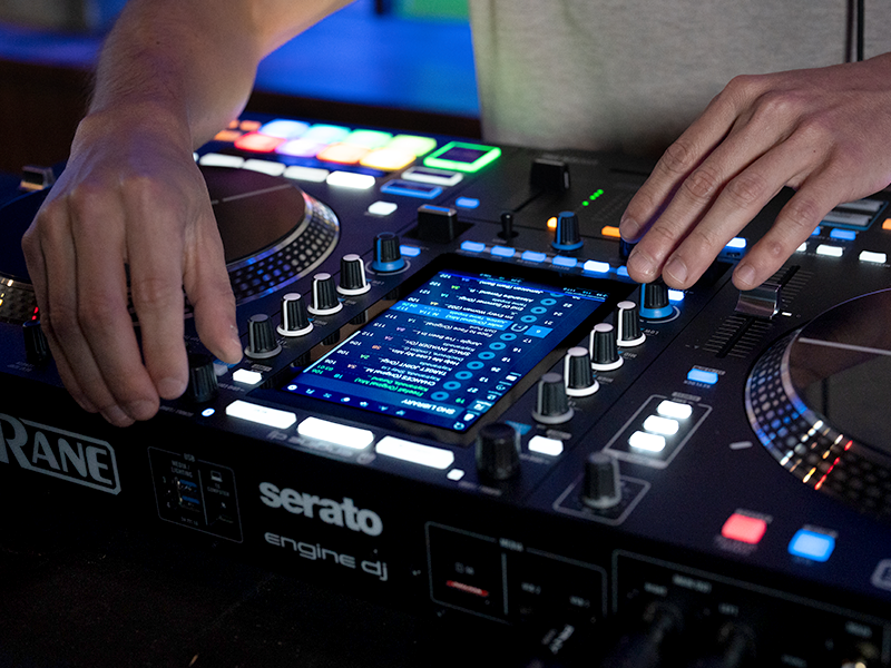 Series of images showing DJ controller equipment with illuminated buttons and control surfaces. Close-up shots demonstrate various angles of the interface and hands operating controls.