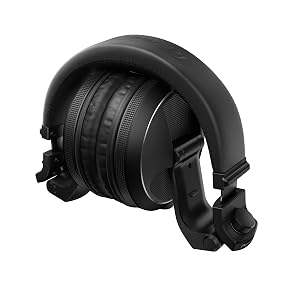 Text reads 'GERMANY'. Black gaming or audio headphones displayed against holiday-themed background with decorative ornaments and festive elements.