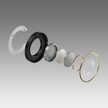 Close-up technical photos of metallic spring mechanism components shown from multiple angles against gray background.