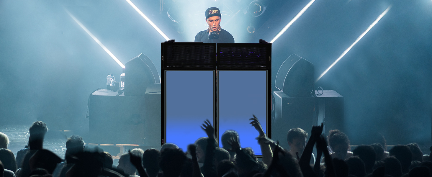 Concert stage setup with illuminated blue booth and dramatic white beam lighting effects, silhouetted crowd visible in foreground.