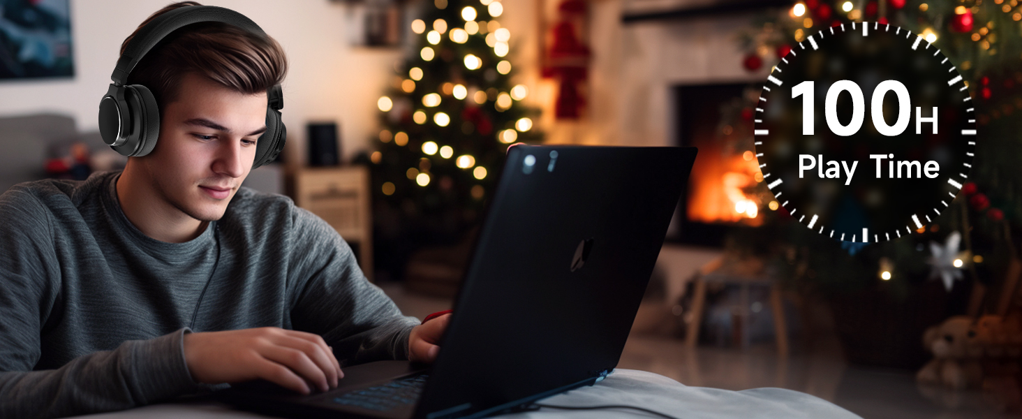 Person using laptop with headphones in cozy room with Christmas tree and fireplace. Circular overlay shows '100h Play Time' text.