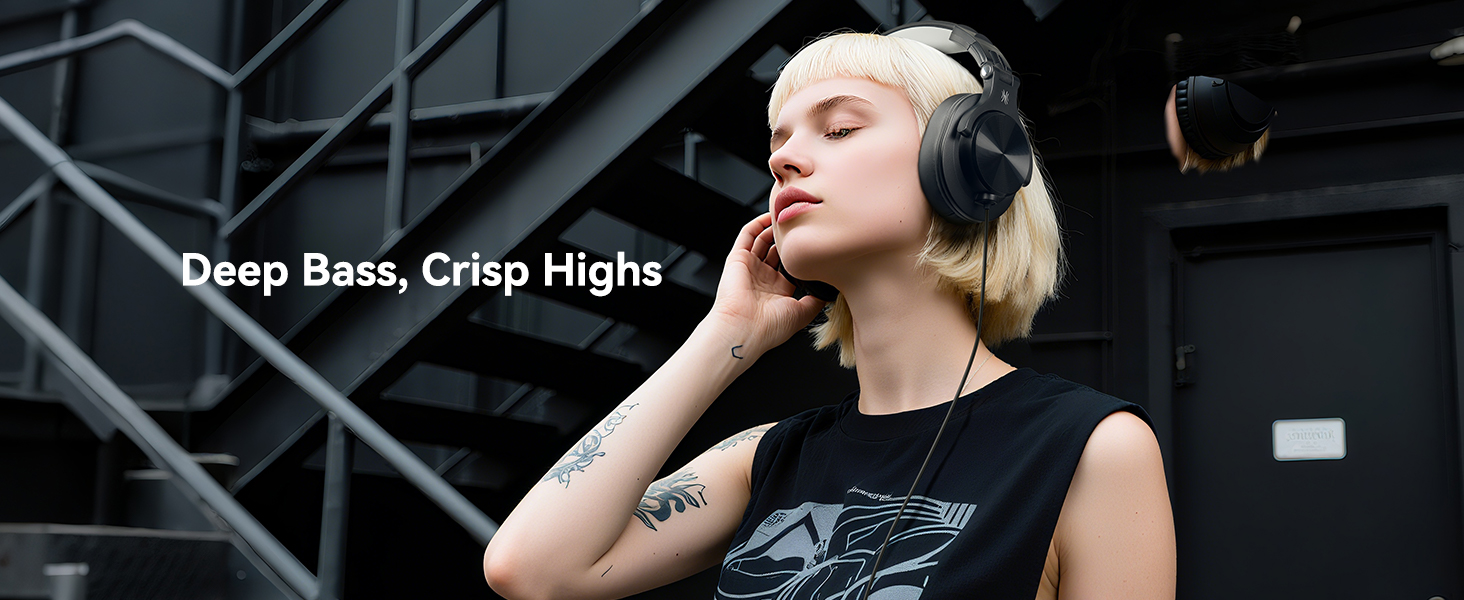Text reads: 'Deep Bass, Crisp Highs'. Person wearing wireless earbuds shown against industrial background.